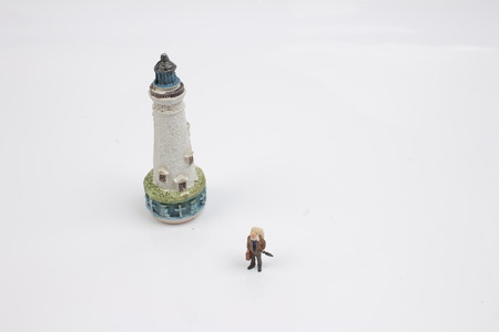 Miniature people traveler concept with lighthouseの写真素材