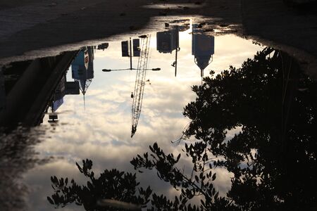 Reflection street  in a puddle on the alley city.の写真素材