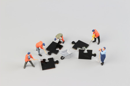 the people collaborate holding up jigsaw puzzle piecesの写真素材