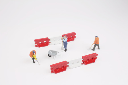 the figure of a man digging concrete roadの写真素材