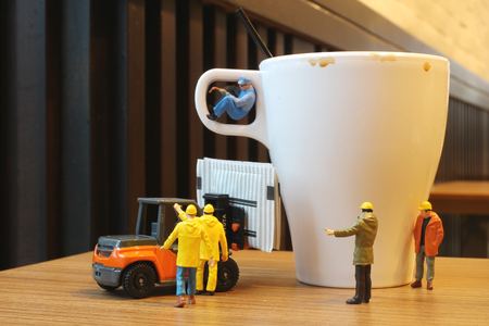 close up Miniature people workers with cup of drinkの写真素材