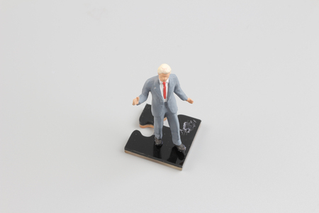 the business people collaborate holding up jigsaw puzzle piecesの写真素材