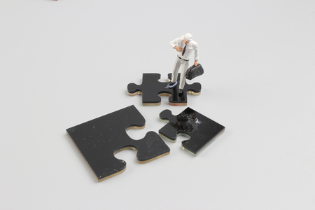 the business people collaborate holding up jigsaw puzzle piecesの写真素材