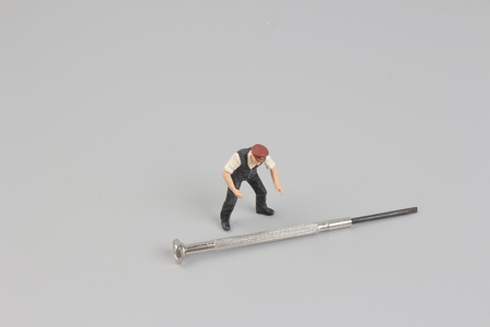 Close up of Miniature gardener people isolate on white backgroundの写真素材