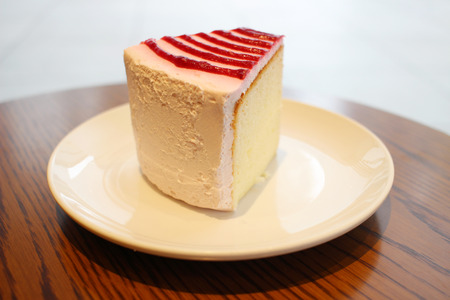 the whipped cream cake on wooden tableの写真素材