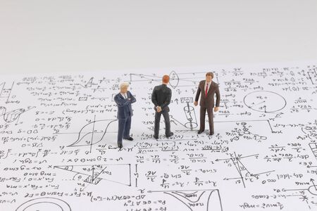 the Tiny figure stands near math formula