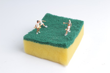 the Tiny toys play tennis on Spongeの写真素材