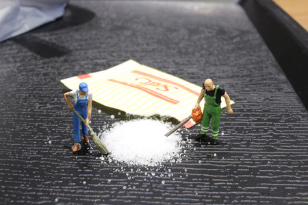 the min woker cleaning up spilled saltの写真素材