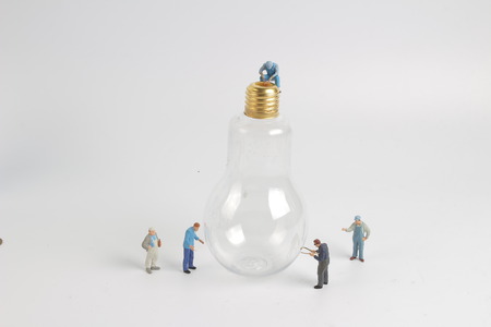 min worker character as electrician with bulbの写真素材