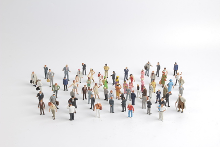 A collection of small miniature people on white backgroundの写真素材