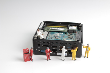 mini of workers on computer mother board