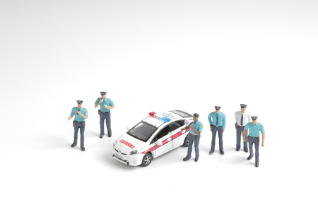 the Police officer stands in with of police carの写真素材