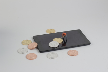 digging Mining Golden bitcoins on keyboard の写真素材