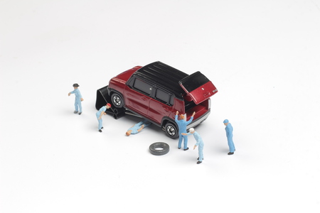 mini  mechanics repairing a car and a tractorの写真素材