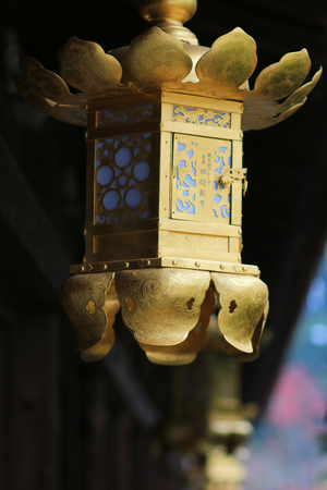 a Golden lantern in Kitano Tenmangu shrine in Kyoto.の写真素材