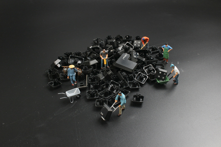a mini people Work on Computer Key board