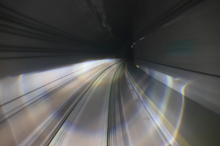 train moving in city rail tunnel with moderate motion blur