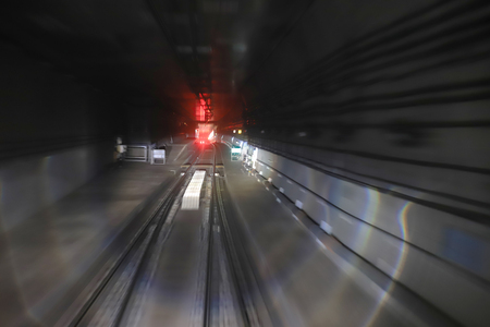 train moving in city rail tunnel with moderate motion blur