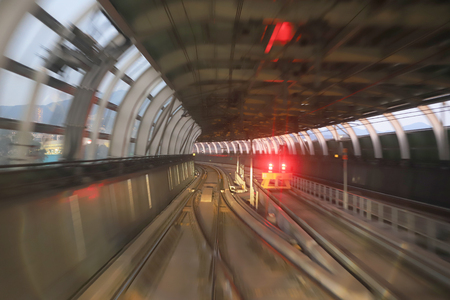 train moving in city rail tunnel with moderate motion blurの写真素材
