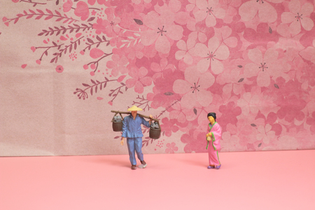 the figure of japanese stand before the cherry backgroundの写真素材