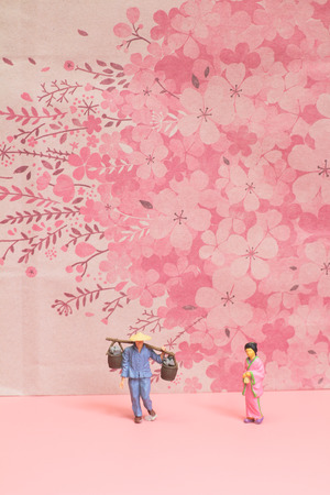 the figure of japanese stand before the cherry backgroundの写真素材