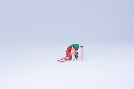 a Mini statue and red vintage oriental rickshaw cabの写真素材