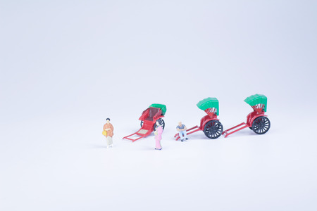 a Mini statue and red vintage oriental rickshaw cabの写真素材