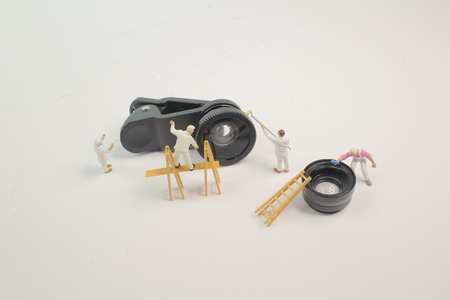 the mini woker clearing the mini lensの写真素材