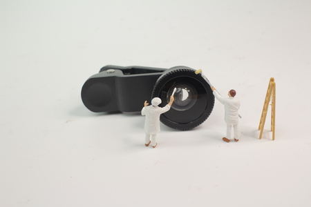 the mini woker clearing the mini lensの写真素材
