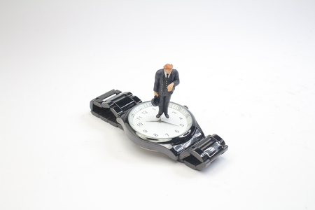 the mini business man figure standing on watchの写真素材