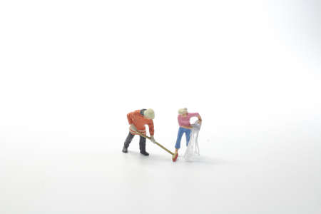 the mini figure are clearing the workの写真素材