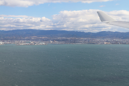 a view of the city near seacoast from windowの写真素材