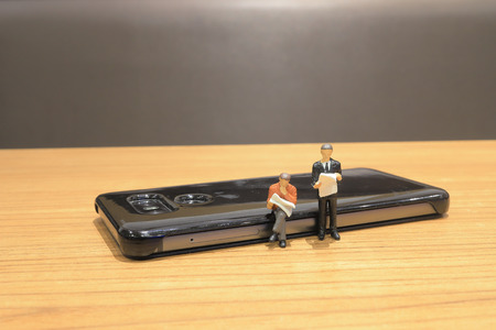 the mini of figure with newspaper on boardの写真素材