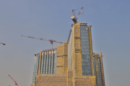 luxury apartments under construction with crane aboveのeditorial素材