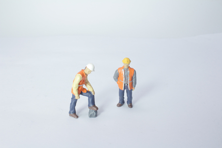 a set of tiny figure on the white boardの写真素材