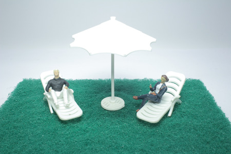 the tiny of  beach deck chair with figure