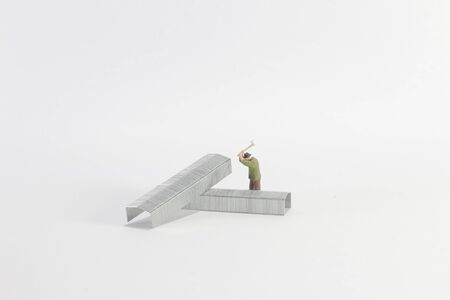 a mini figure man cut the iron on board