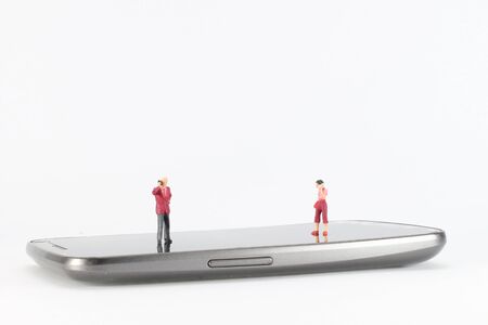 toys figure are talking via mobile phoneの写真素材