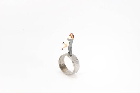 mini figure of happy couple is hugging with a ringの写真素材
