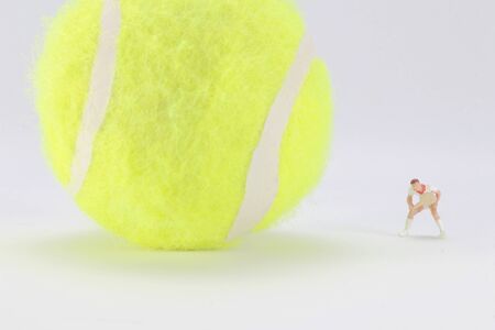 A Tiny toys of tennis player with big tennis ballの写真素材