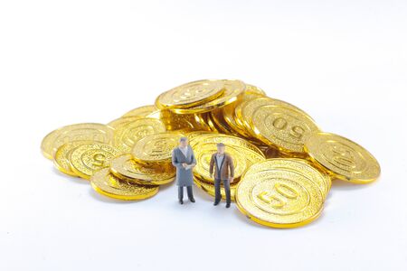 the business figure stand on the gold coins.の写真素材