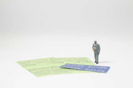 Full body isolated on white. Friendly delivery man carrying a package,