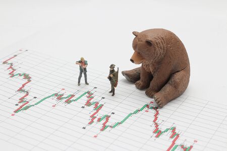 mini figure of hunter kill the bear, concept of  market trendの写真素材