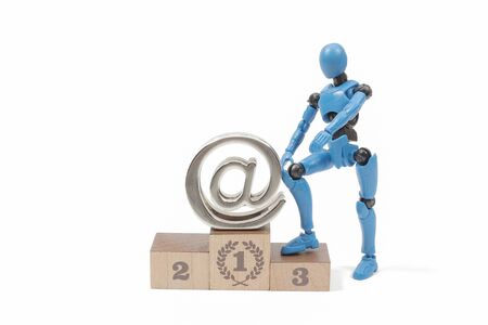 toy figure of robot man with at symbol at Stage podiumの写真素材