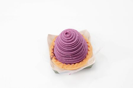 a Cup cake with purple cream on write backgroundの写真素材