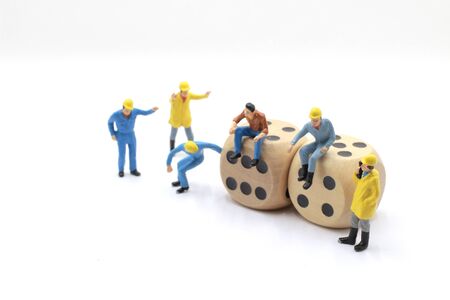 image use for business concept. Workers mini figures surrounded by gambling elements