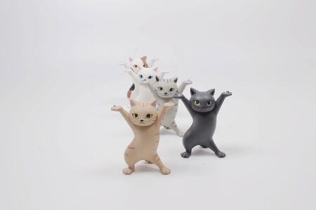 Cat figure stand by a plastic toy on table.の写真素材