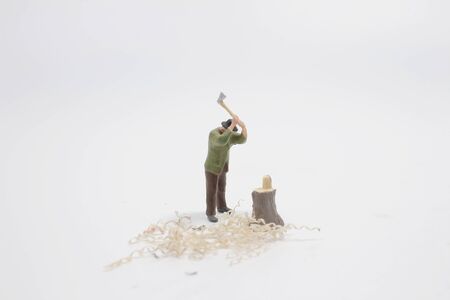 a Mini workmen working together in felling and cutting trees close upの写真素材