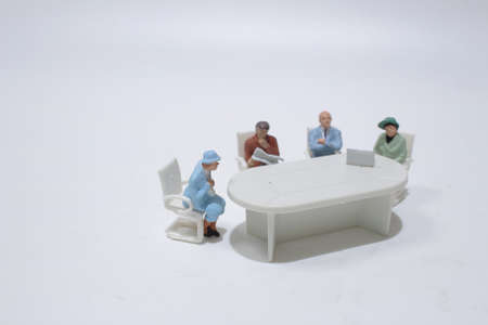 figure of business people negotiating at meeting table