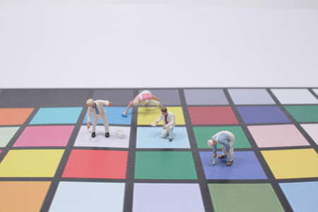 a Mini people: Group of worker painting colorful paperの写真素材